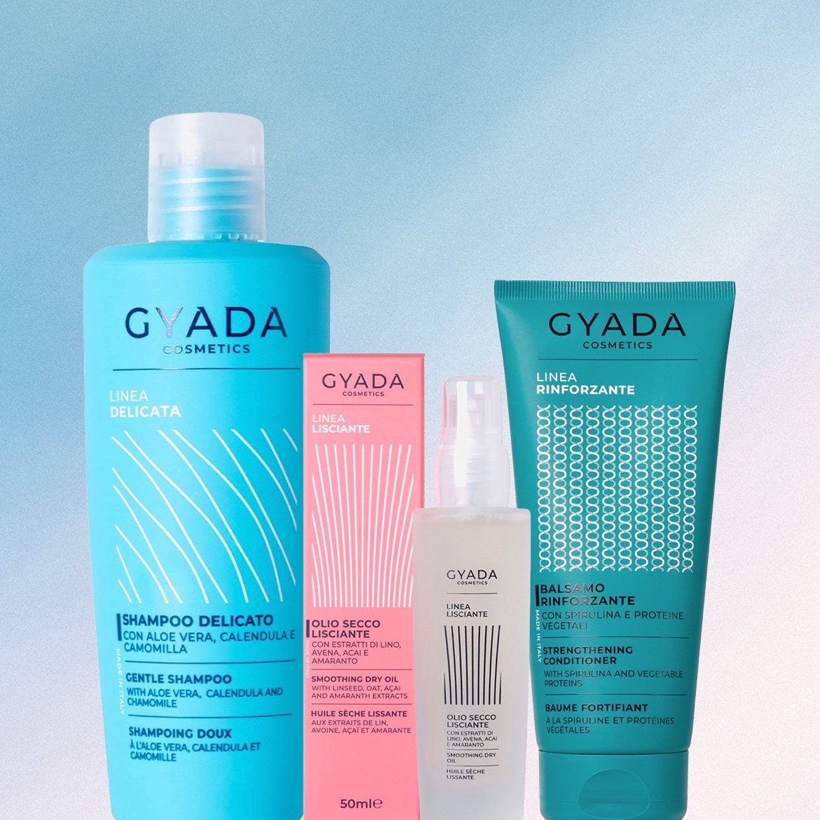 Una collezione di prodotti per capelli Gyada Cosmetics, tra cui uno shampoo delicato azzurro, un olio secco lisciante rosa e bianco, e un balsamo rinforzante verde acqua, tutti con etichette che descrivono i loro ingredienti e benefici.