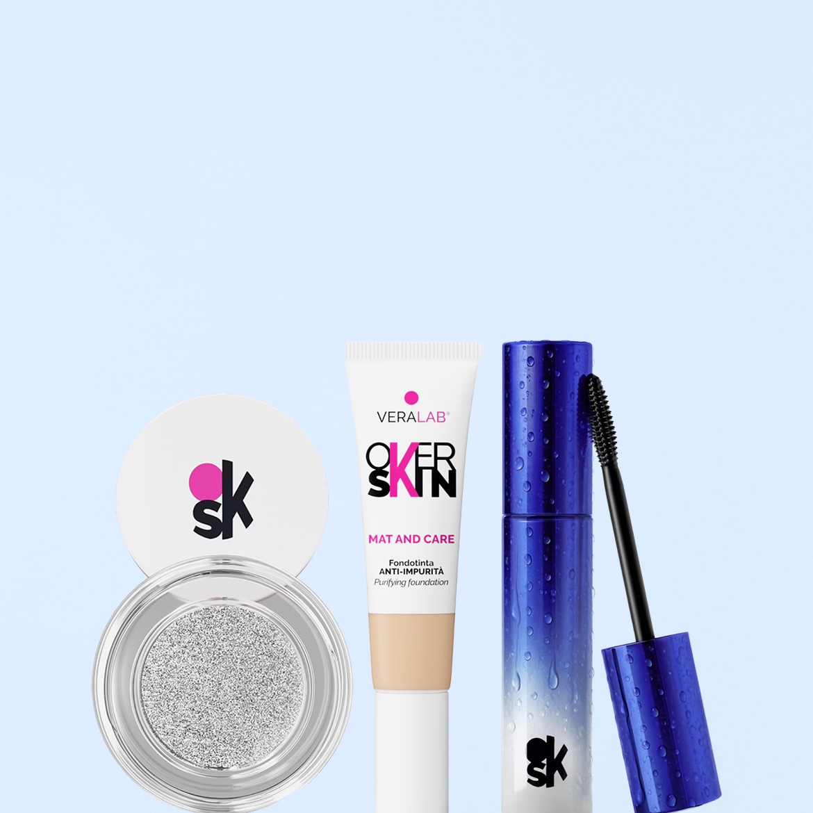 Scopri il trio di prodotti Veralab Over Skin: cipria illuminante in confezione bianca, fondotinta Mat and Care in tubetto bianco e mascara blu waterproof per un look impeccabile.