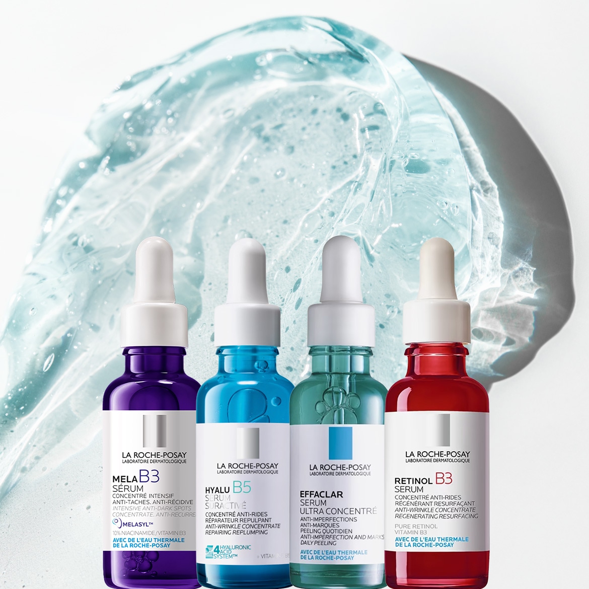 Ecco quattro sieri La Roche-Posay: Mela B3 in flacone viola per macchie scure, Hyalu B5 in flacone blu per rughe, Effaclar in flacone verde per imperfezioni e Retinol B3 in flacone rosso per rigenerare la pelle.