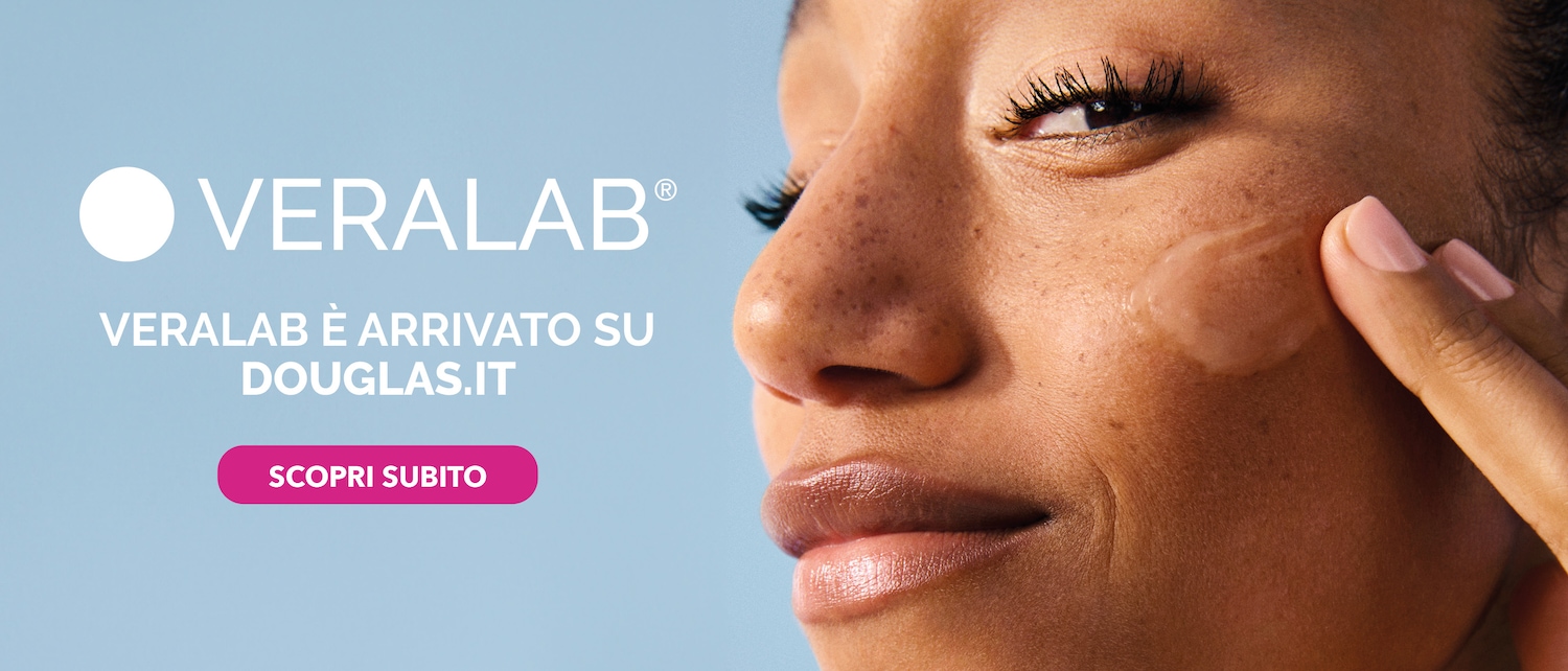 Close-up of a woman applying Verlab product to her face, with the text "VERALAB È ARRIVATO SU DOUGLAS.IT SCOPRI SUBITO" inviting you to discover it now.