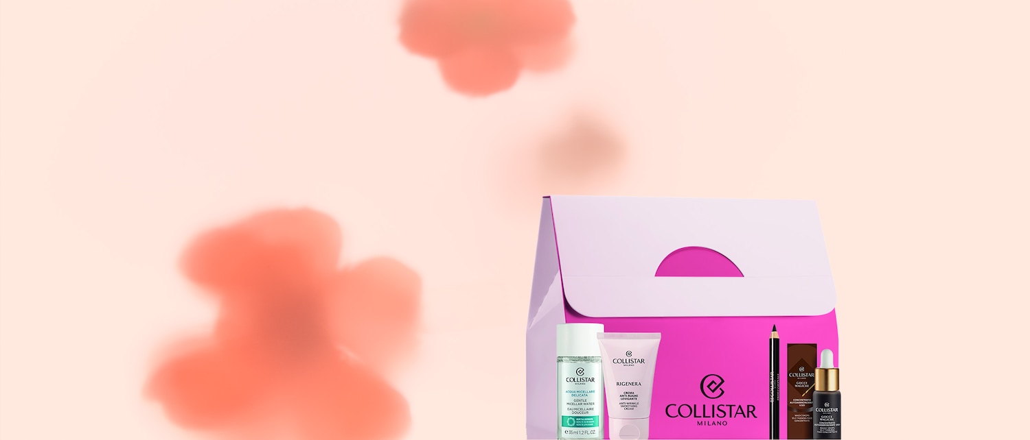 Ecco un set di prodotti Collistar, tra cui acqua micellare delicata, crema rigenera levigante, matita occhi professionale e gocce magiche autoabbronzanti viso, presentati in un'elegante confezione regalo.