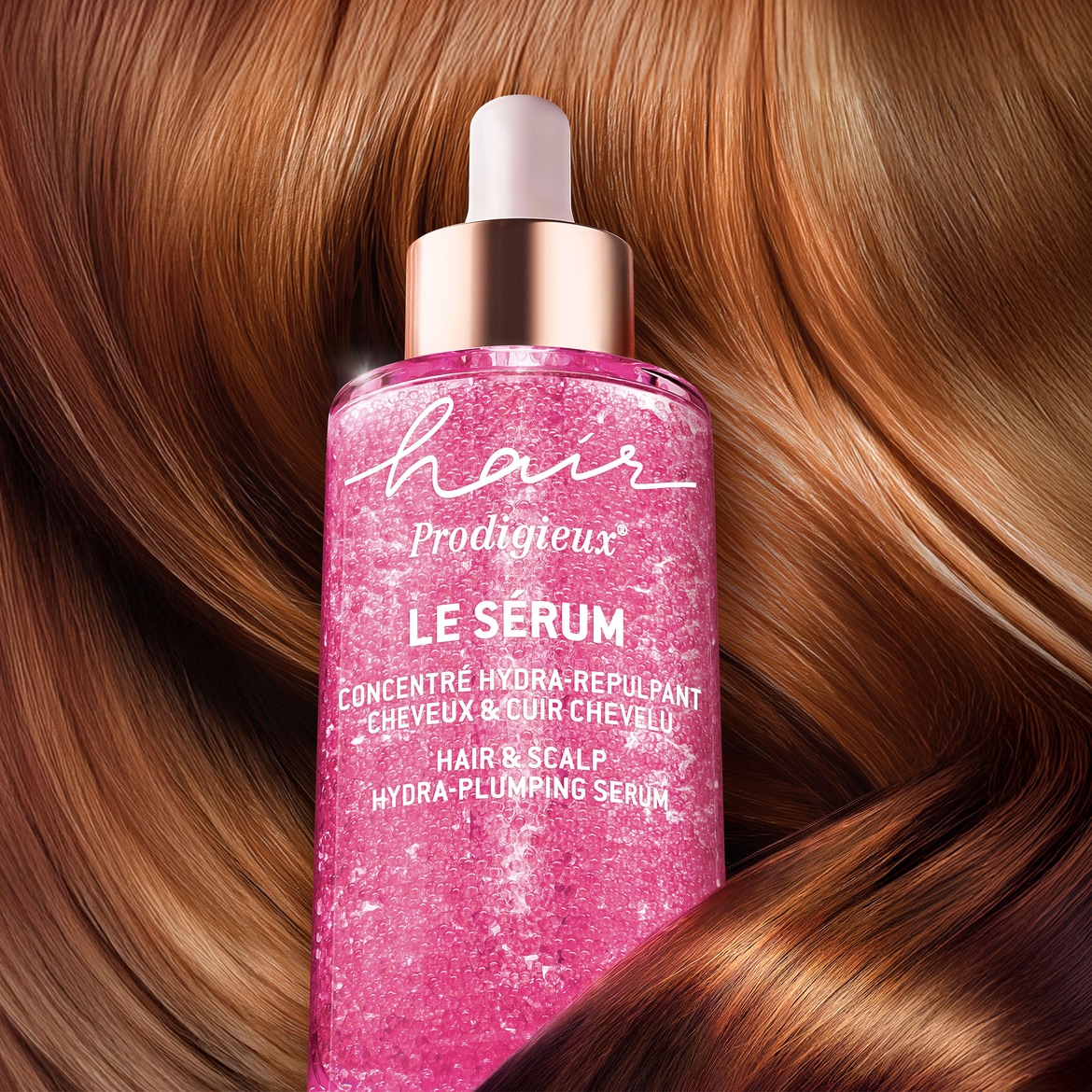 Siero idratante e rimpolpante per capelli e cuoio capelluto Hair Prodigieux, in confezione rosa trasparente con contagocce bianco.