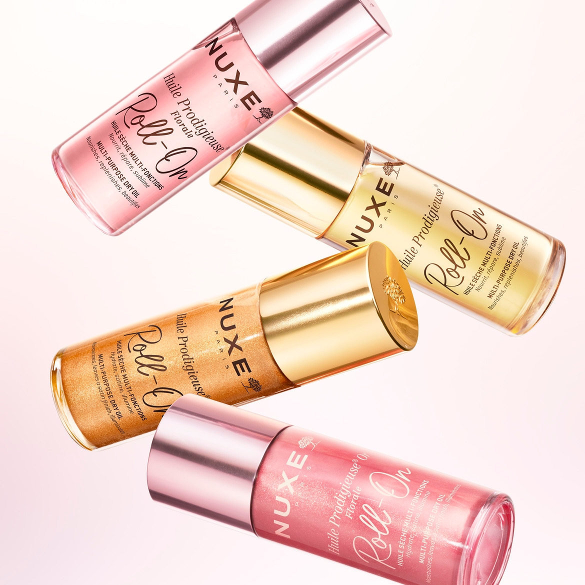 Ecco l'olio secco multiuso Nuxe in tre varianti: rosa, oro e trasparente, ognuna in un flacone roll-on con tappo dorato o rosa.